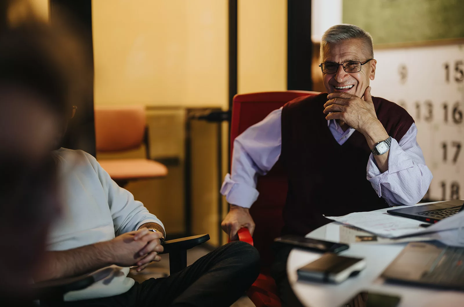 A smiling business owner in discussion, perhaps with a firm like Liminal Partners, who handle business financial succession plans.